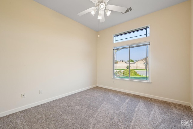 spare room featuring carpet floors, plenty of natural light, and ceiling fan