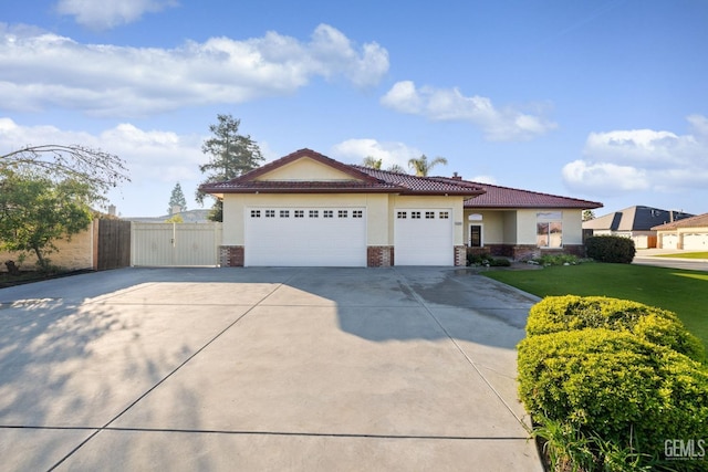 view of front of property with a garage and a front lawn