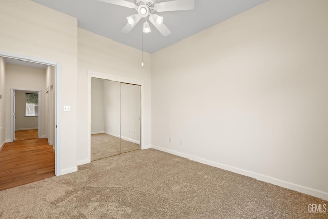 unfurnished bedroom featuring carpet floors, a closet, and ceiling fan