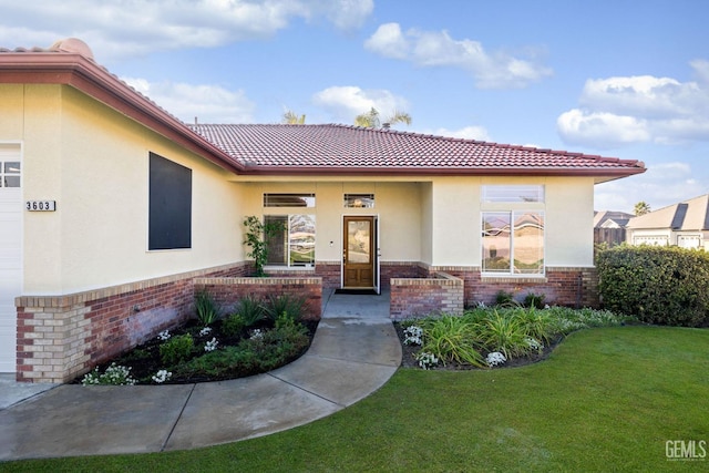 property entrance with a lawn