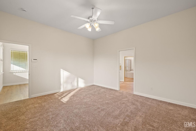 carpeted spare room featuring ceiling fan