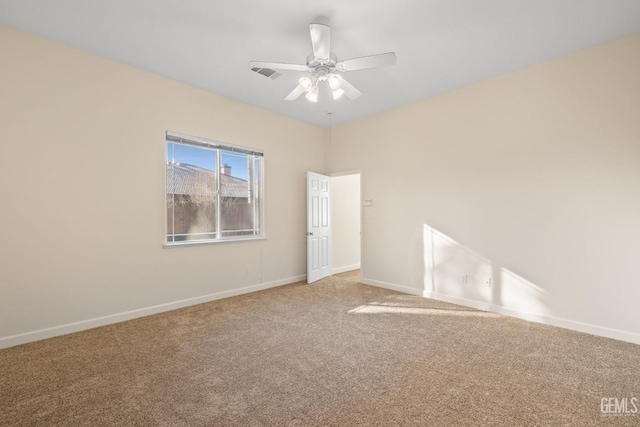 carpeted spare room with ceiling fan