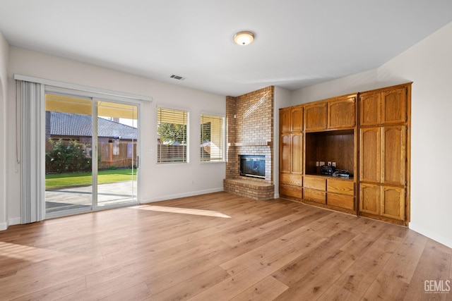 unfurnished living room featuring light hardwood / wood-style floors and a fireplace