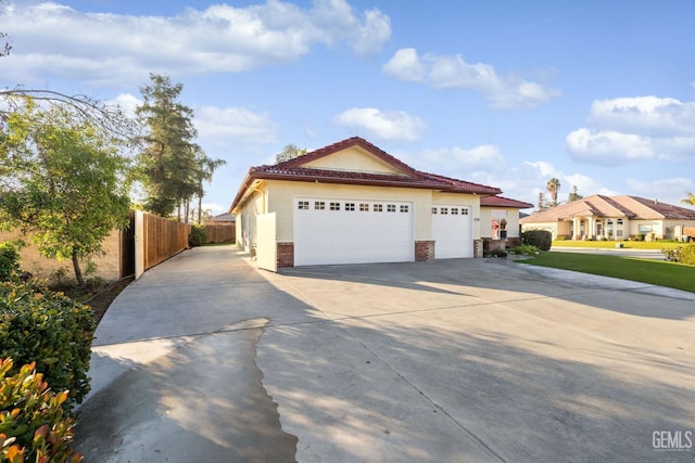 mediterranean / spanish-style home with a garage