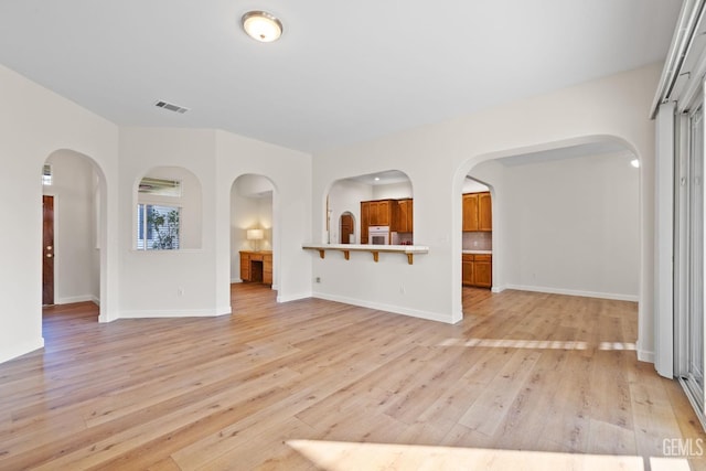 unfurnished living room featuring light wood-type flooring