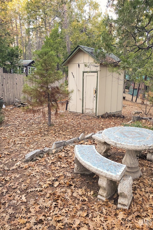 view of shed featuring fence