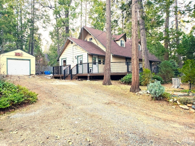 view of front of home with an outbuilding, a garage, and a deck