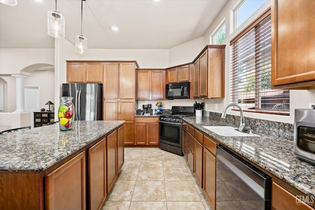 9510 Midnight Creek Way, Bakersfield, CA 93311 - kitchen featuring dishwasher, black microwave, gas stove, freestanding refrigerator, and arched walkways