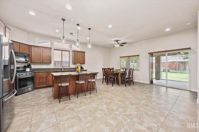 9510 Midnight Creek Way, Bakersfield, CA 93311 - kitchen featuring appliances with stainless steel finishes, a center island, recessed lighting, ceiling fan, and a breakfast bar