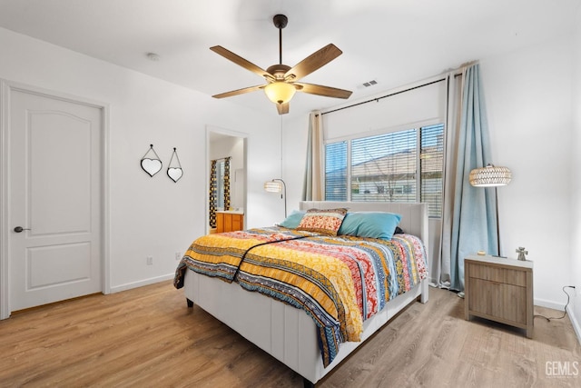 bedroom with ceiling fan and light hardwood / wood-style floors