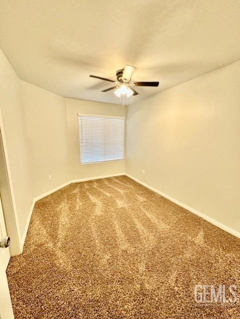 unfurnished room featuring baseboards, carpet, and a ceiling fan