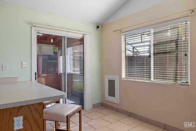 5414 Tyner Ln, Bakersfield, CA 93307 - dining area featuring vaulted ceiling, healthy amount of natural light, and light tile patterned flooring