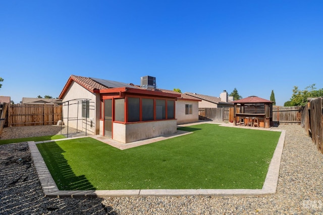 5414 Tyner Ln, Bakersfield, CA 93307 - back of house with solar panels, central air condition unit, a gazebo, stucco siding, and a patio