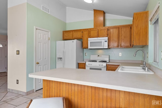 5414 Tyner Ln, Bakersfield, CA 93307 - kitchen with white appliances, a sink, light tile patterned flooring, light countertops, and a peninsula