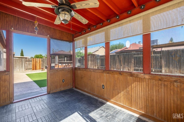 5414 Tyner Ln, Bakersfield, CA 93307 - unfurnished sunroom with wood walls and beam ceiling