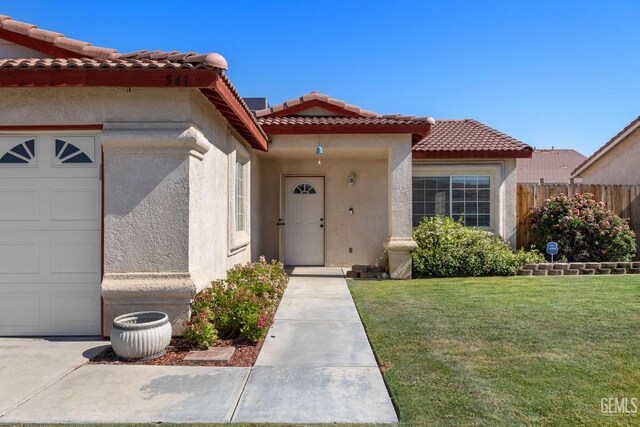 5414 Tyner Ln, Bakersfield, CA 93307 - view of front of house featuring stucco siding, an attached garage, and a tile roof