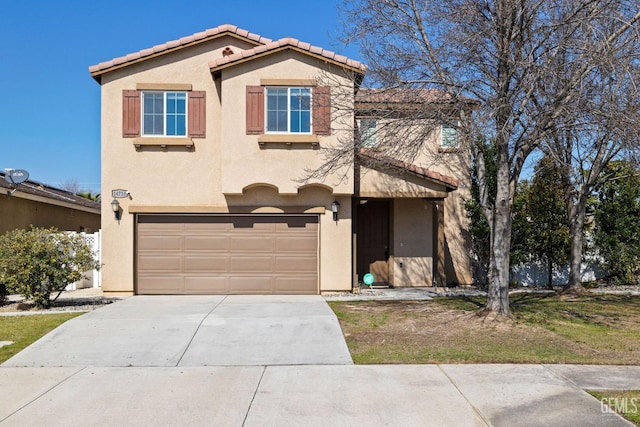 view of front facade featuring concrete driveway, a tiled roof, an attached garage, and stucco siding