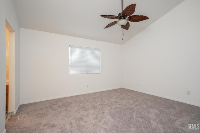 carpeted empty room featuring ceiling fan and lofted ceiling