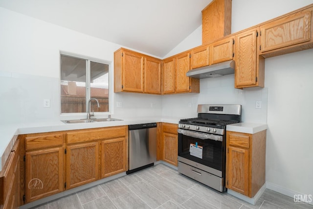 kitchen featuring vaulted ceiling, stainless steel appliances, and sink