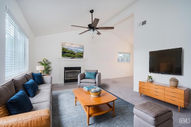 carpeted living room featuring vaulted ceiling and ceiling fan