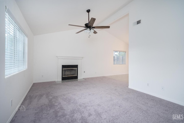 unfurnished living room with ceiling fan, high vaulted ceiling, and carpet