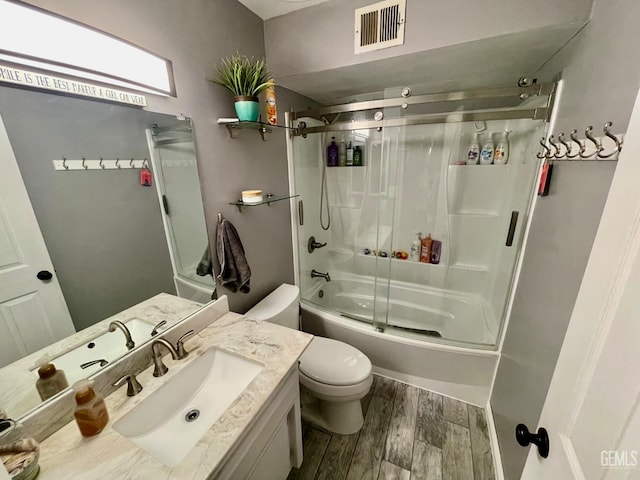 320 E Woodrow St, Taft, CA 93268 - full bathroom featuring enclosed tub / shower combo, vanity, and wood finished floors