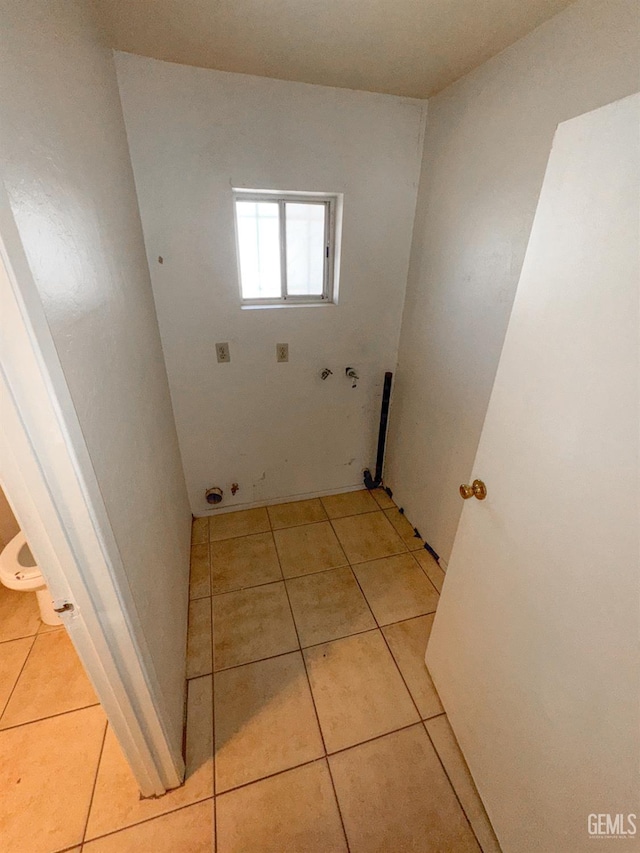 1065 12th St, Wasco, CA 93280 - washroom with hookup for an electric dryer, light tile patterned floors, and washer hookup