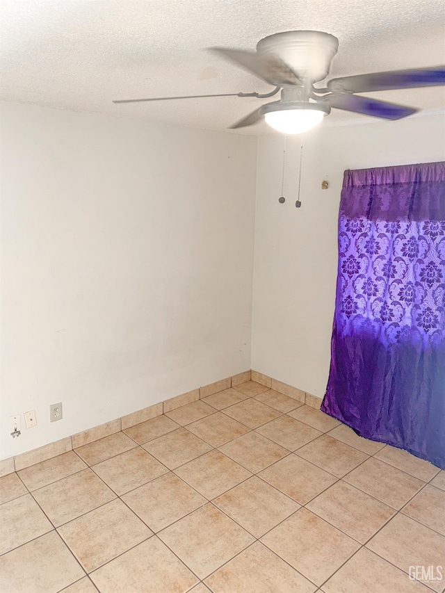 1065 12th St, Wasco, CA 93280 - unfurnished room featuring a ceiling fan, light tile patterned flooring, and a textured ceiling