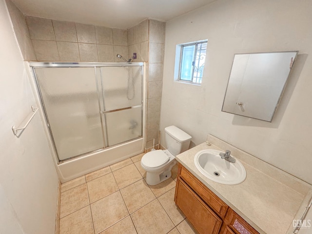 1065 12th St, Wasco, CA 93280 - full bathroom with vanity, tile patterned floors, and bath / shower combo with glass door
