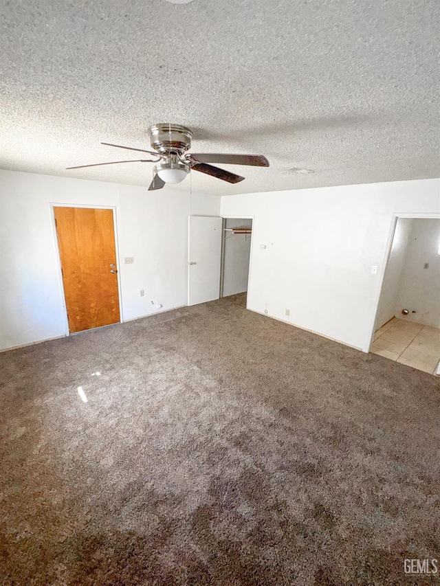 1065 12th St, Wasco, CA 93280 - unfurnished bedroom with light colored carpet, a ceiling fan, and a textured ceiling