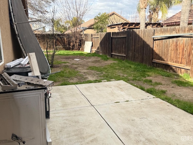 view of yard featuring a patio area and a fenced backyard