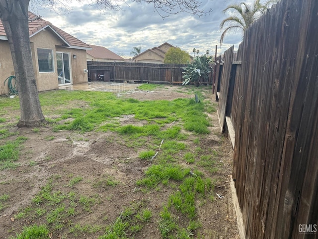 view of yard with a patio area and a fenced backyard