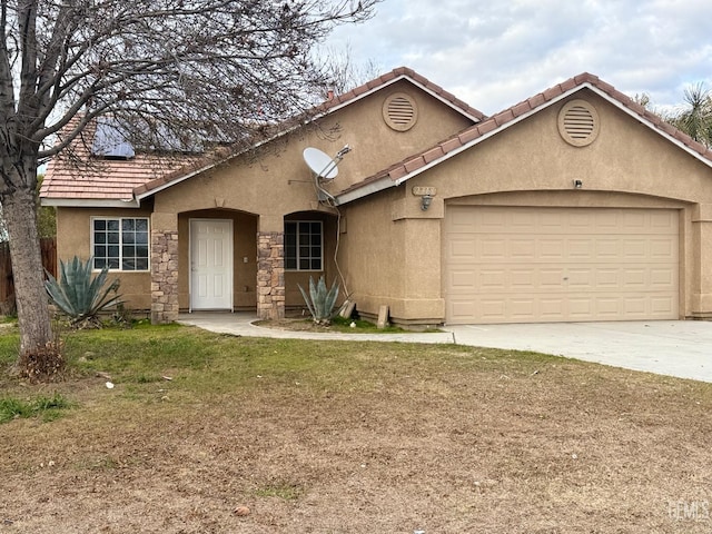 view of front of house featuring concrete driveway, a tile roof, an attached garage, a front lawn, and stucco siding