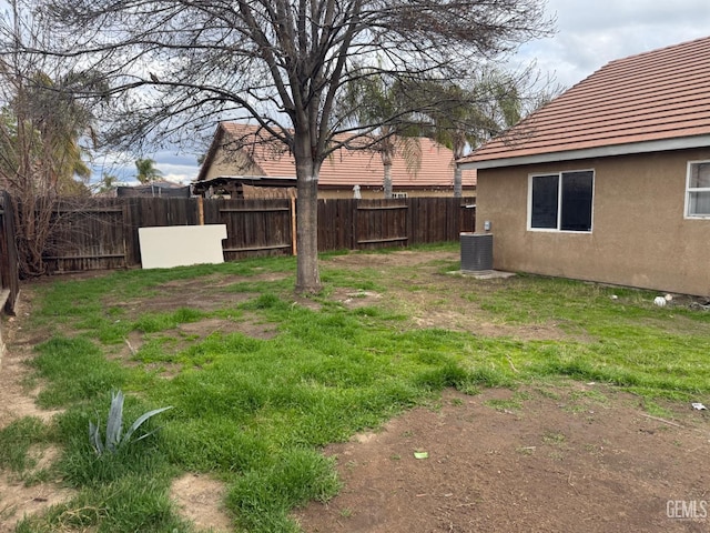 view of yard with cooling unit and fence