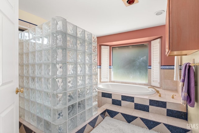 bathroom with a relaxing tiled tub