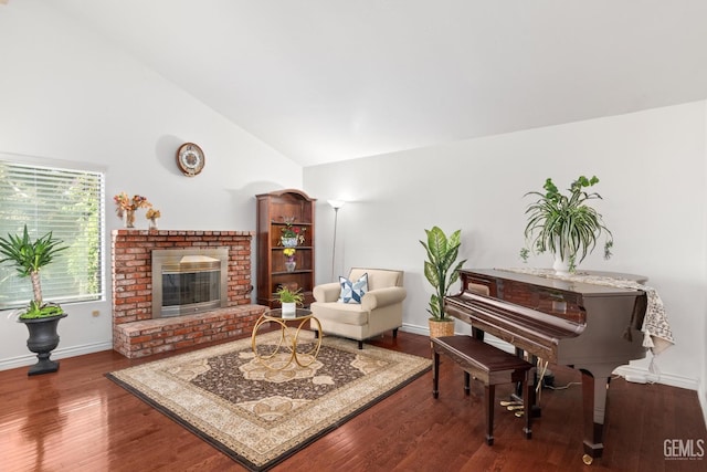 interior space with hardwood / wood-style flooring, high vaulted ceiling, and a fireplace