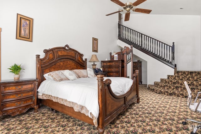 bedroom with a high ceiling, ceiling fan, and carpet flooring