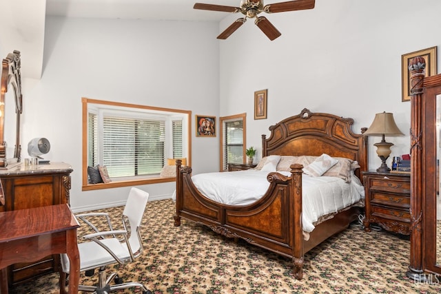 bedroom with a high ceiling, carpet floors, and ceiling fan