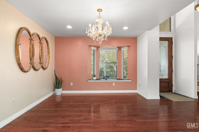 interior space with a chandelier and dark hardwood / wood-style flooring