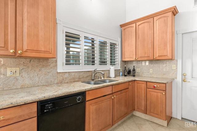 kitchen featuring light tile patterned flooring, sink, light stone counters, tasteful backsplash, and black dishwasher