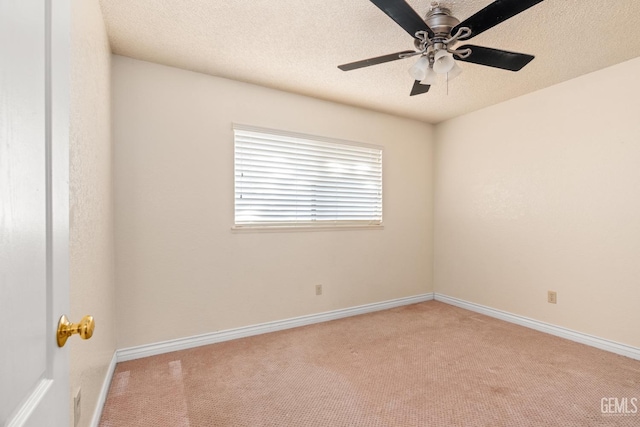 carpeted spare room with ceiling fan and a textured ceiling