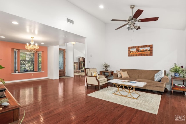 living room with dark wood-type flooring, high vaulted ceiling, and ceiling fan with notable chandelier