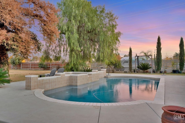 view of pool at dusk