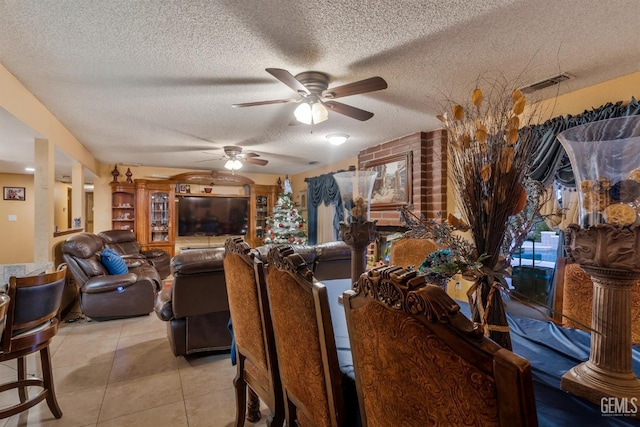 dining room featuring light tile patterned flooring, ceiling fan, and a textured ceiling