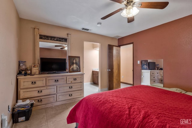 bedroom featuring light tile patterned flooring, ceiling fan, and connected bathroom