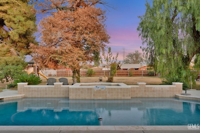 view of pool at dusk