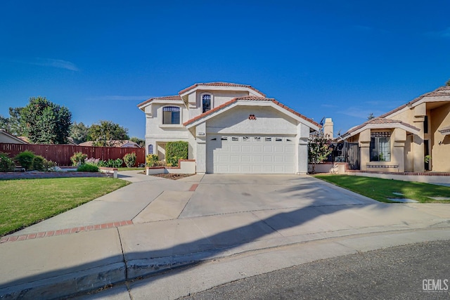 mediterranean / spanish-style house featuring a front yard and a garage