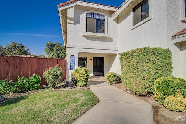 doorway to property with a lawn