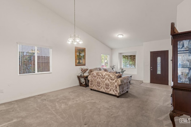 carpeted living room featuring high vaulted ceiling and a notable chandelier