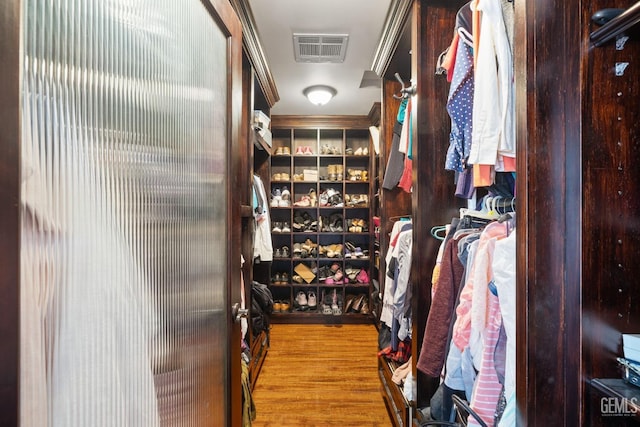 spacious closet featuring hardwood / wood-style floors